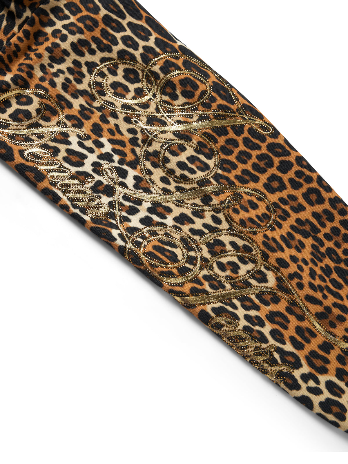 A close-up of a leopard print fabric with a tan and black base, overlaid with a metallic gold embroidered scroll pattern, shown on a white background.