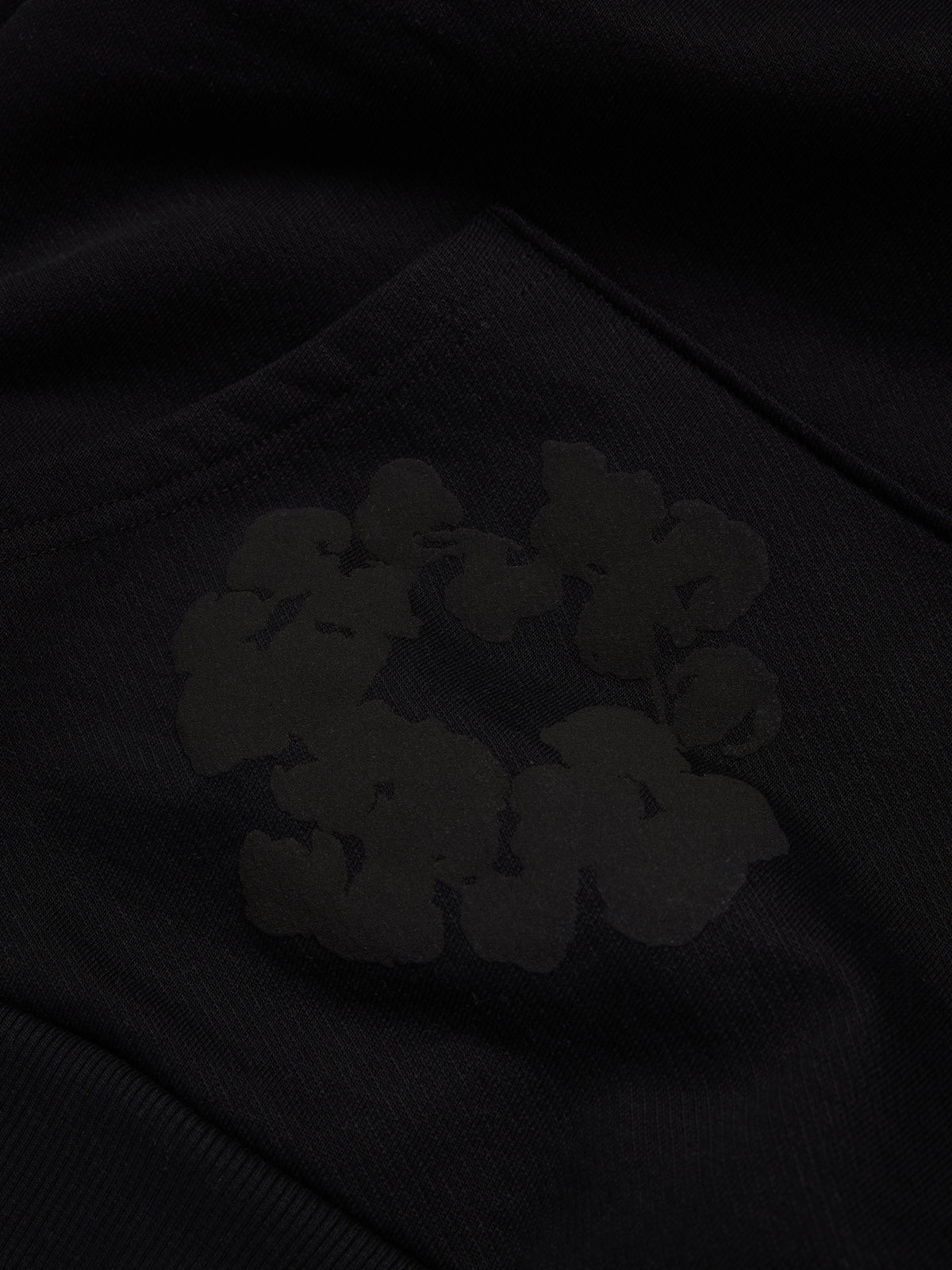 Black Denim Tears hoodie with cloud design on a dark background