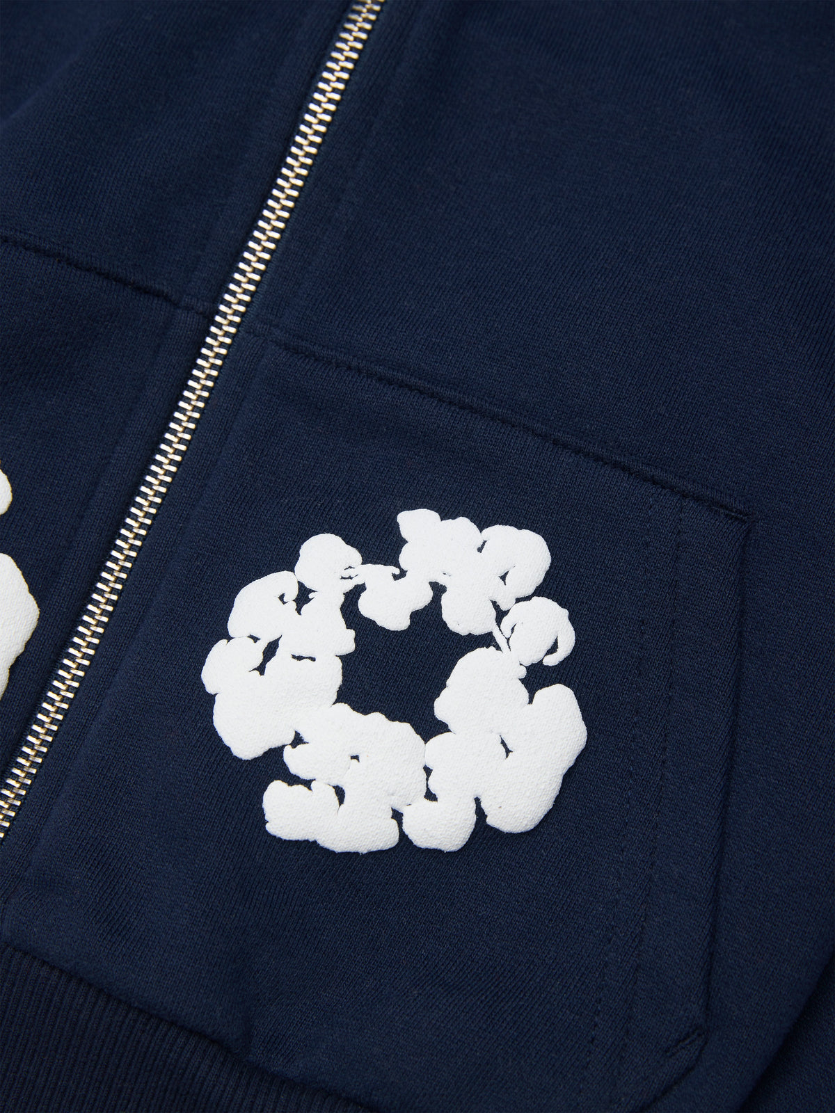 Navy blue Denim Tears hoodie with white floral design on a pocket
