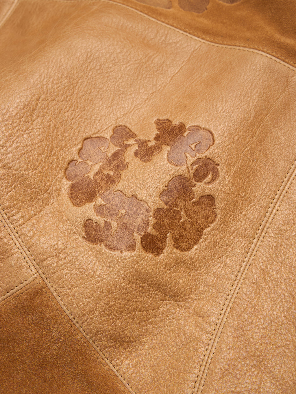 Brown leather surface with a floral pattern