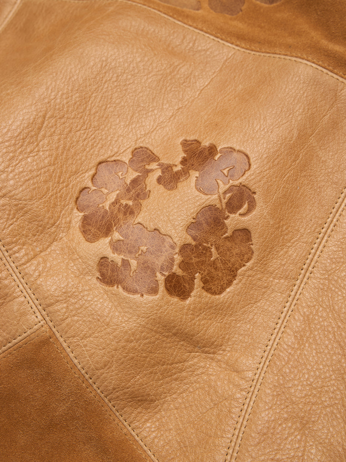 Brown leather surface with a floral pattern