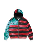 A zip-up Denim Tears hoodie featuring a stylized American flag design with watercolor effects. The left side of the body and the sleeves are decorated with a teal blue field and white stars, while the right side features horizontal red and black stripes.